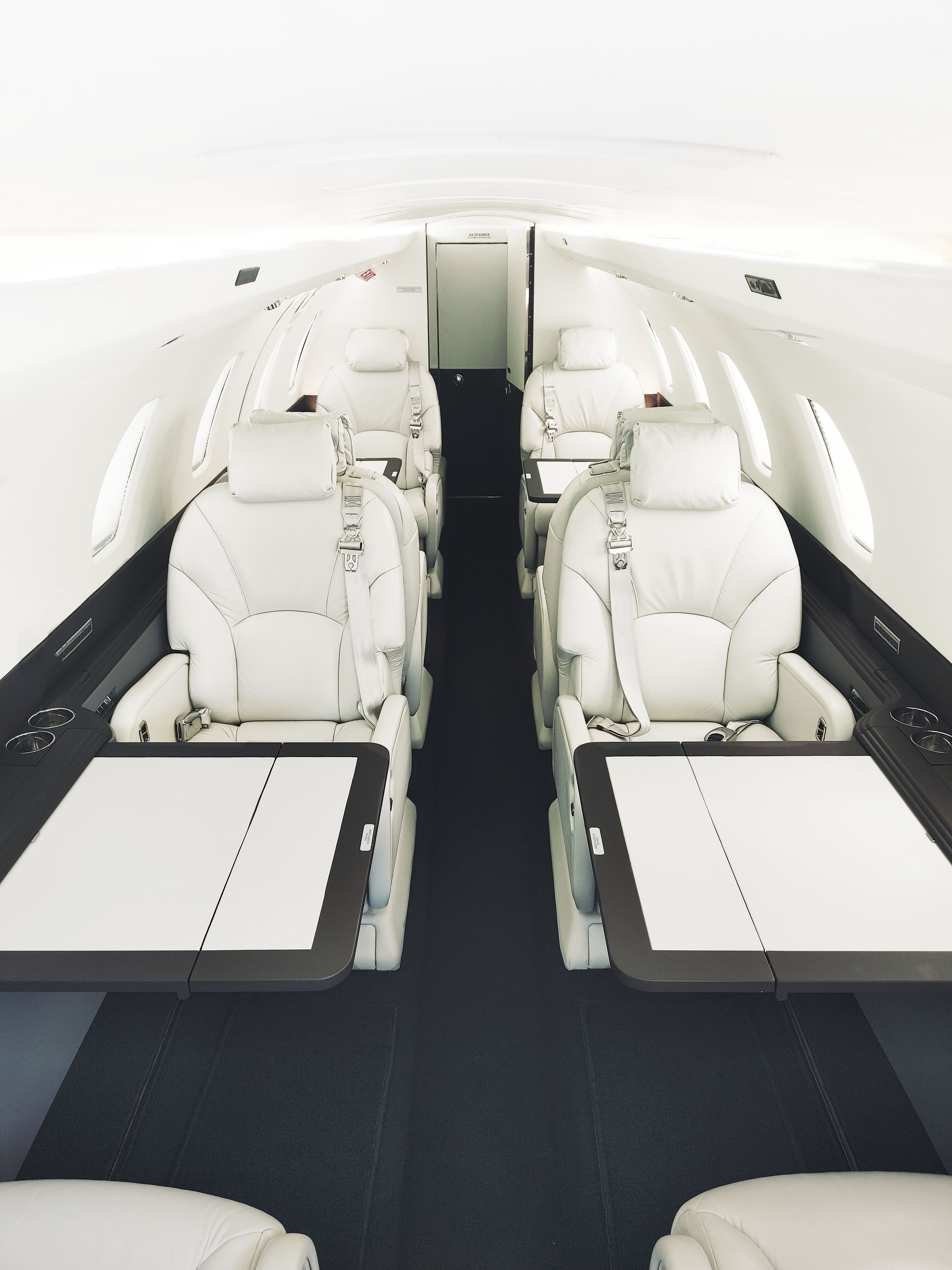 Citation X white leather interior cabin with tables