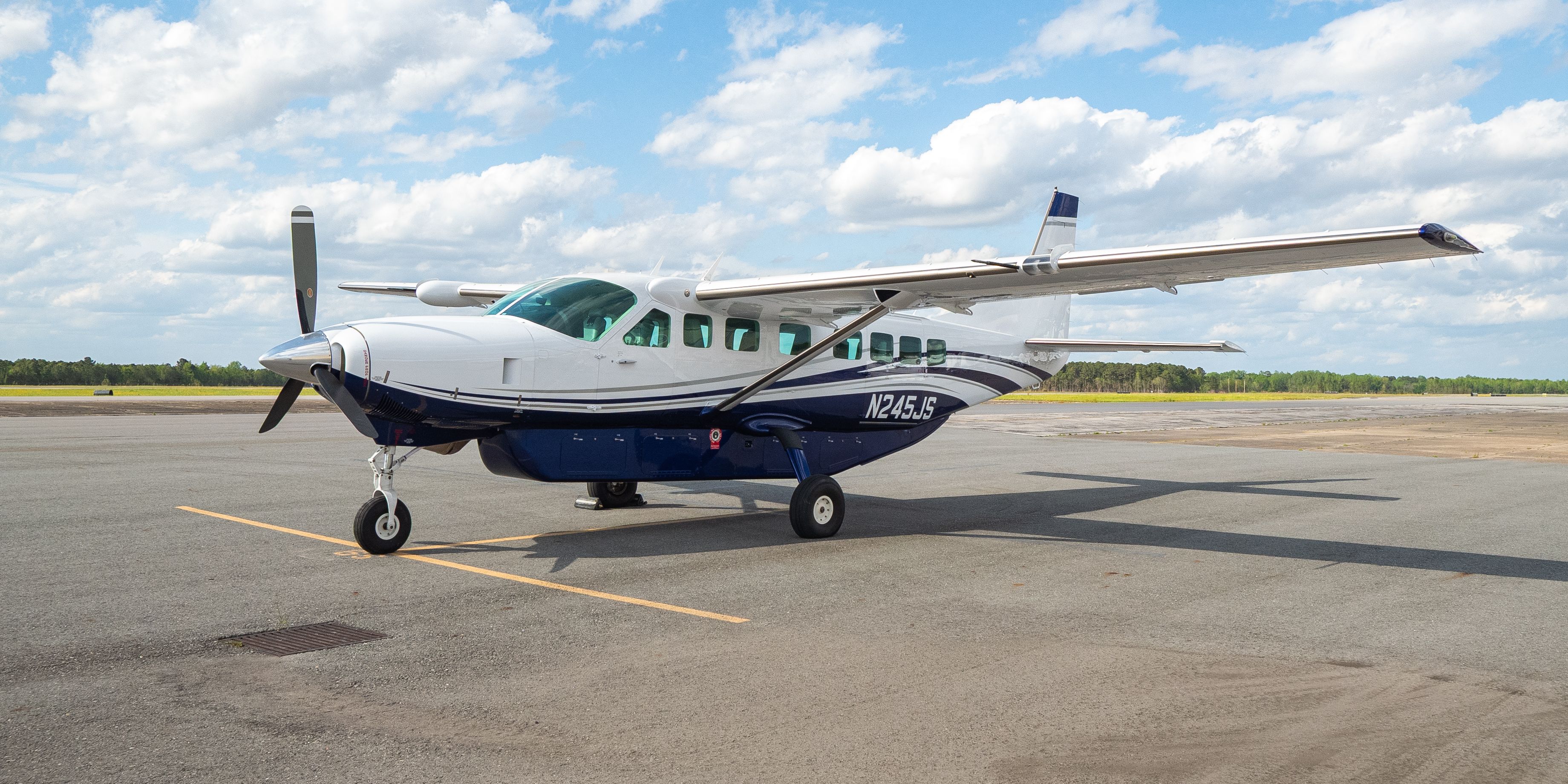 A flyExclusive Cessna Caravan on wheels, parked on the ramp