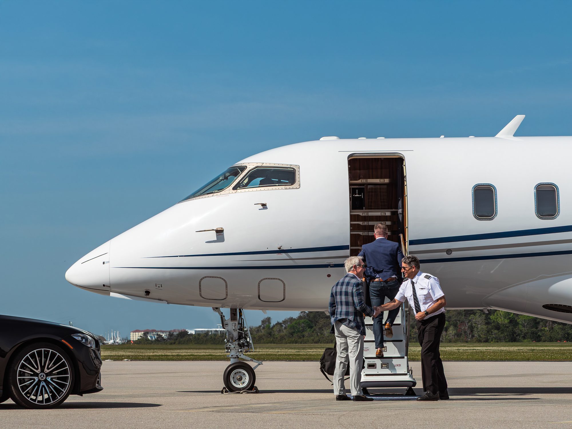 Passengers boarding a flyExclusive Challenger 350 as the captain sees them aboard