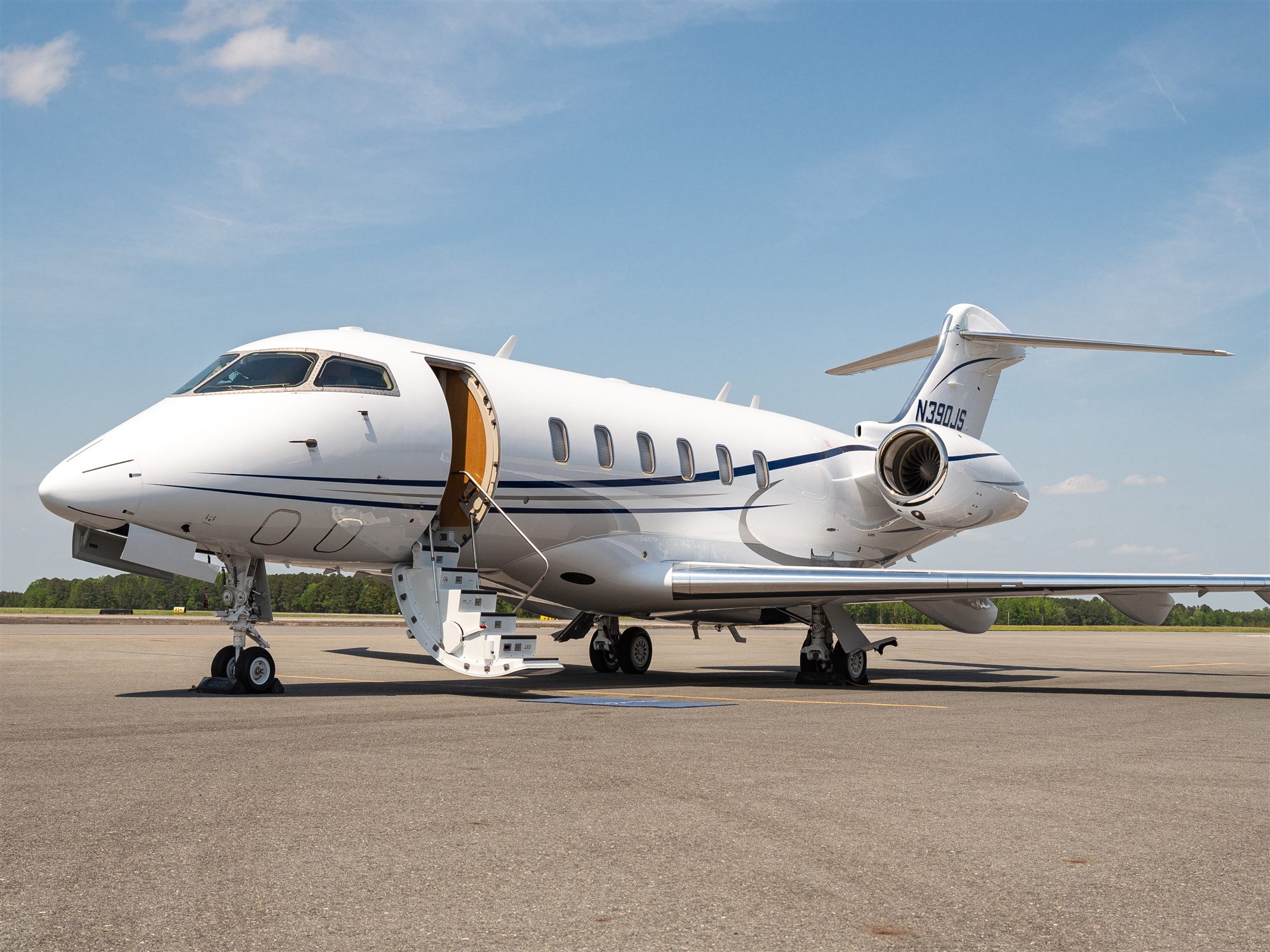 A flyExclusive Challenger 350 on the ramp at dusk
