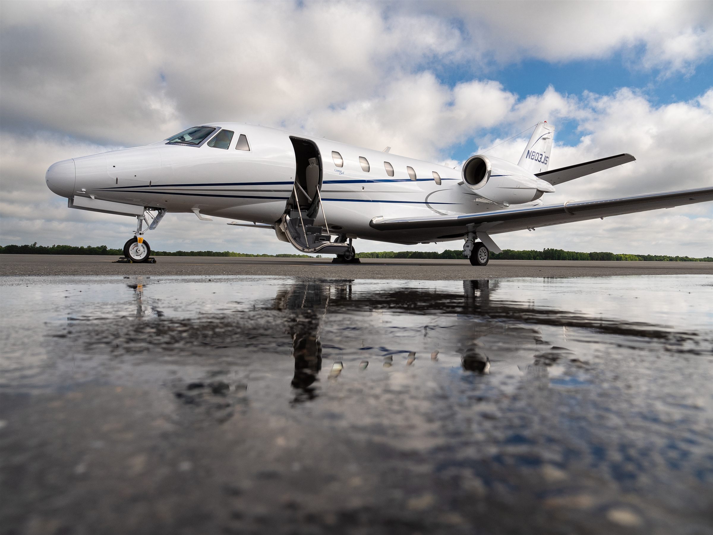 A flyExclusive Citation Excel on a wet ramp with the airstairs down
