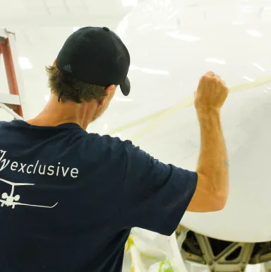 Technician in the flyExclusive paint facility